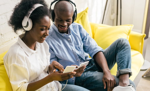 couple with headphones listening to music